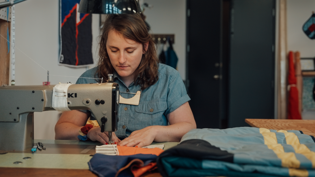 Marylin B. Armand using a sewing machine.